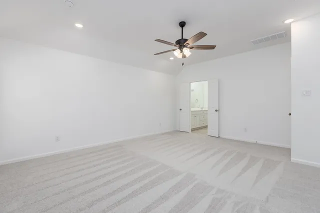 a view of an empty room with a fan