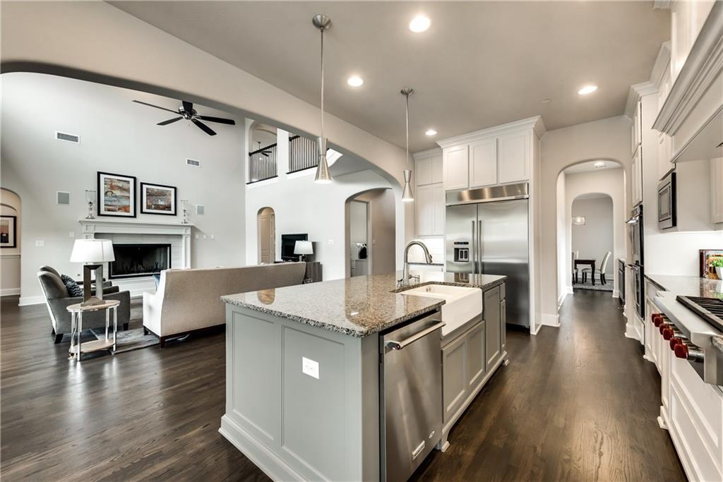 6271 Pitchfork Ranch Drive Frisco, TX 75036 - Photo 1 of 1 a large white kitchen with lots of counter space dining table and chairs