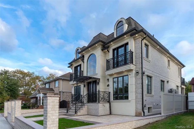 a front view of a house with a garden