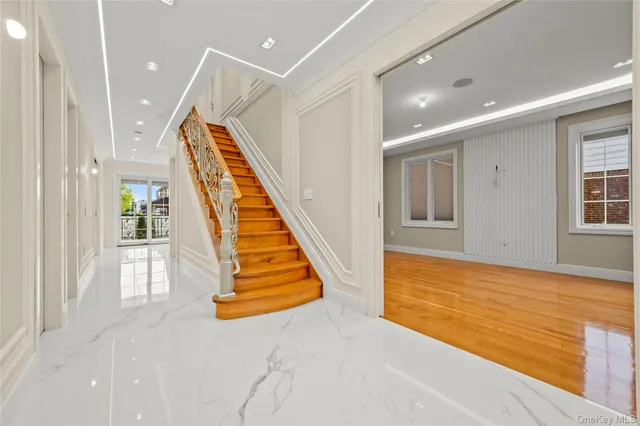 a view of entryway and hall with wooden floor