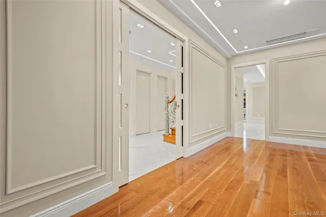 a view of a big room with wooden floor and windows