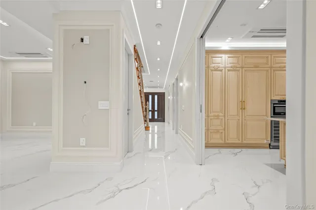 a view of a hallway with wooden shelves