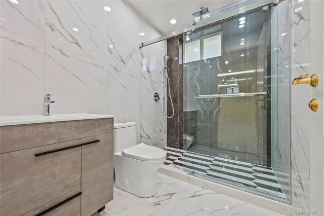 a bathroom with a sink a toilet and shower