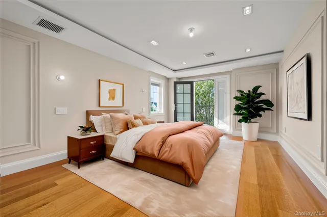a spacious bedroom with a large bed and a potted plant