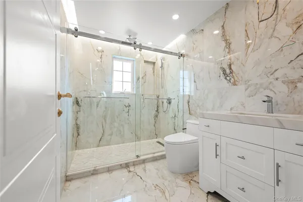 a bathroom with a shower toilet and sink