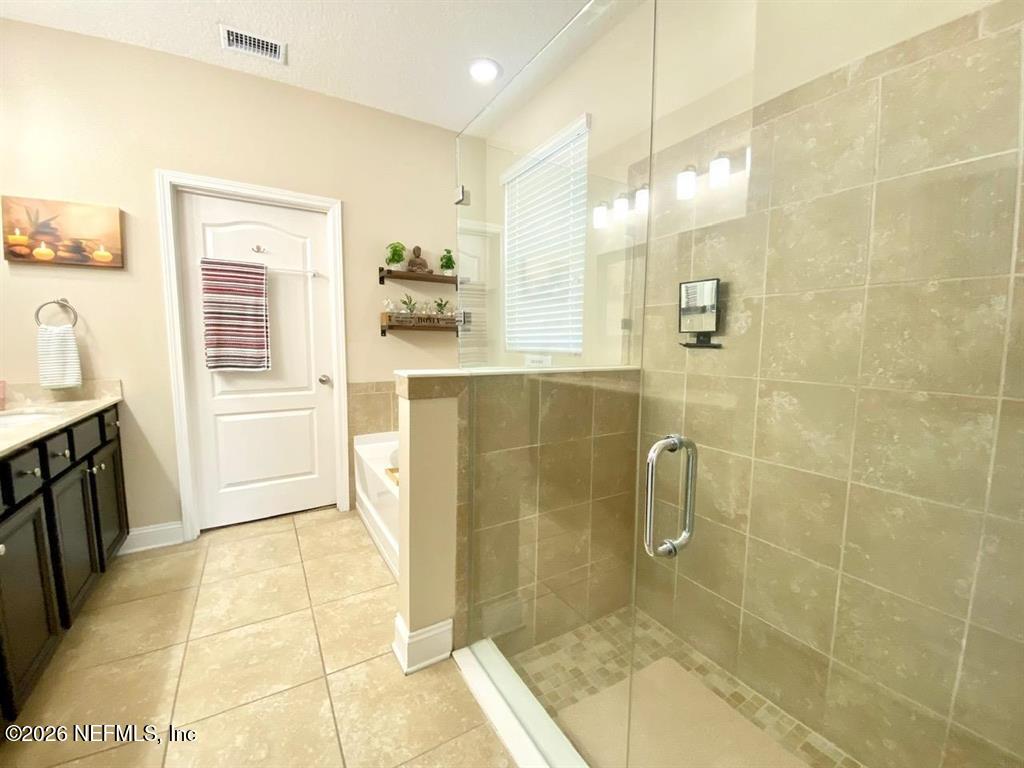 115 Sierras Loop St. Augustine, FL 32086 - Photo 29 of 65 a bathroom with a granite countertop shower