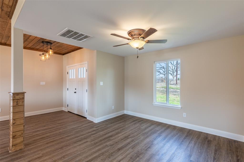 315 Private Road 7327 Emory, TX 75440 - Photo 16 of 39 a view of an empty room with a window and wooden floor