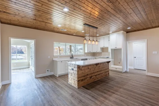 a room with wooden floors and ceiling fan