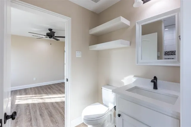 a bathroom with a sink a toilet a shower and a mirror