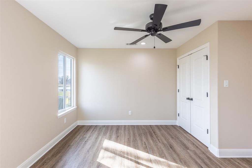 315 Private Road 7327 Emory, TX 75440 - Photo 23 of 39 a view of a livingroom with a hardwood floor and a ceiling fan