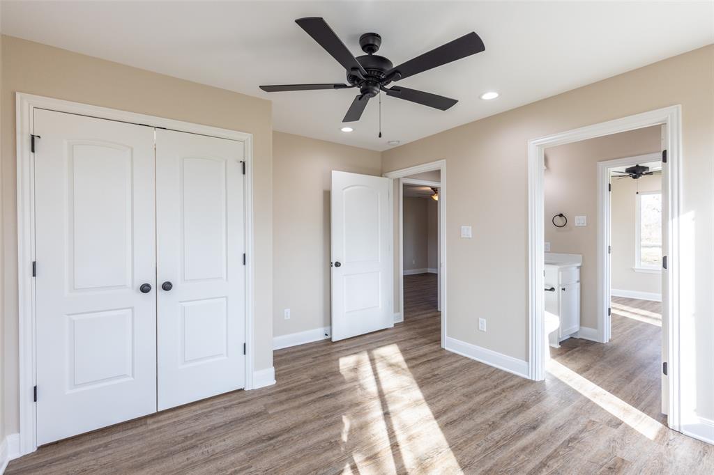 315 Private Road 7327 Emory, TX 75440 - Photo 24 of 39 a view of a livingroom with wooden floor and a ceiling fan