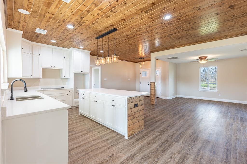 315 Private Road 7327 Emory, TX 75440 - Photo 26 of 39 a kitchen with stainless steel appliances granite countertop a sink stove and wooden floors