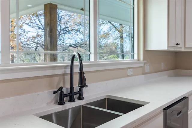 a kitchen with a sink and large window