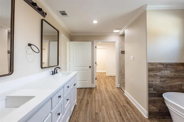 a spacious bathroom with a double vanity sink and a mirror