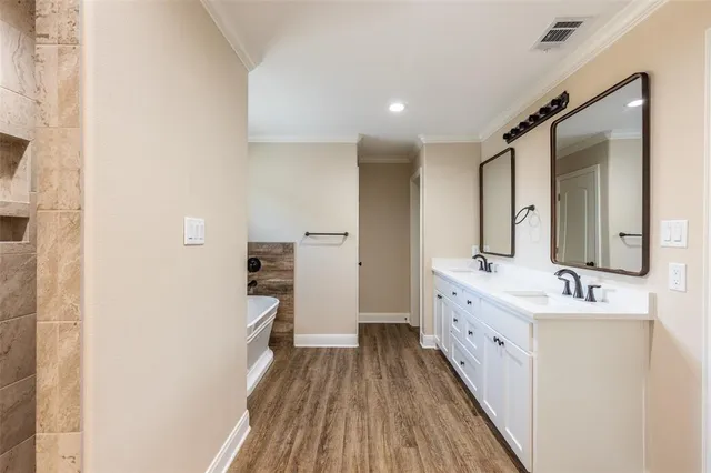 a bathroom with a double vanity sink and mirror