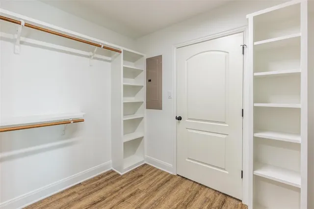 a view of walk in closet with empty racks