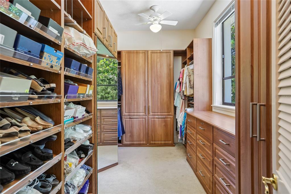 17810 Crawley Road Odessa, FL 33556 - Photo 42 of 76 a view of walk in closet with clothes and shoes