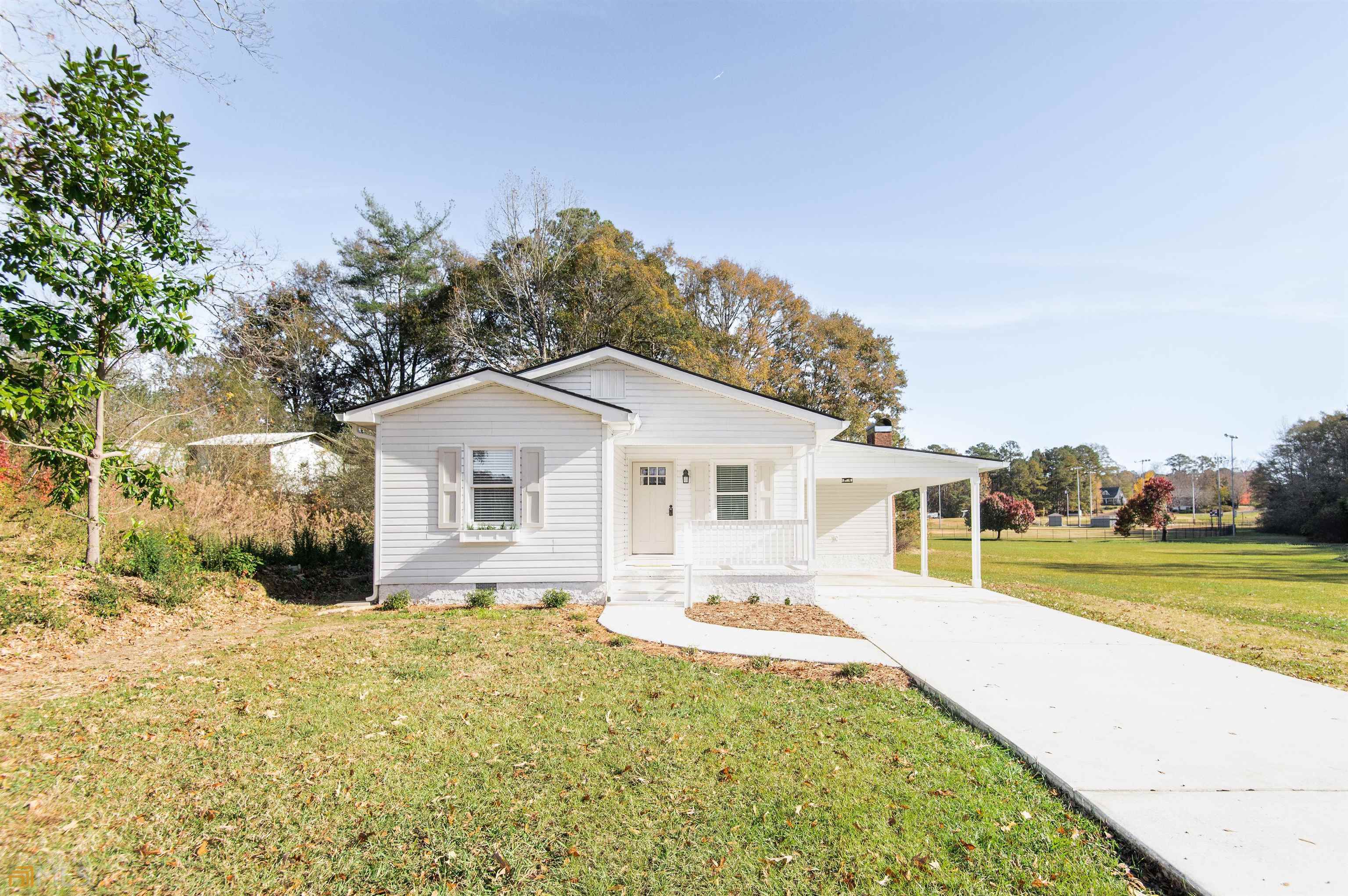 133 Perryman Bridge Road Heflin, AL 36264 - Photo 1 of 1 a front view of a house with a yard table and chairs
