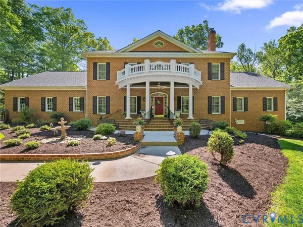 a front view of a house with garden and patio