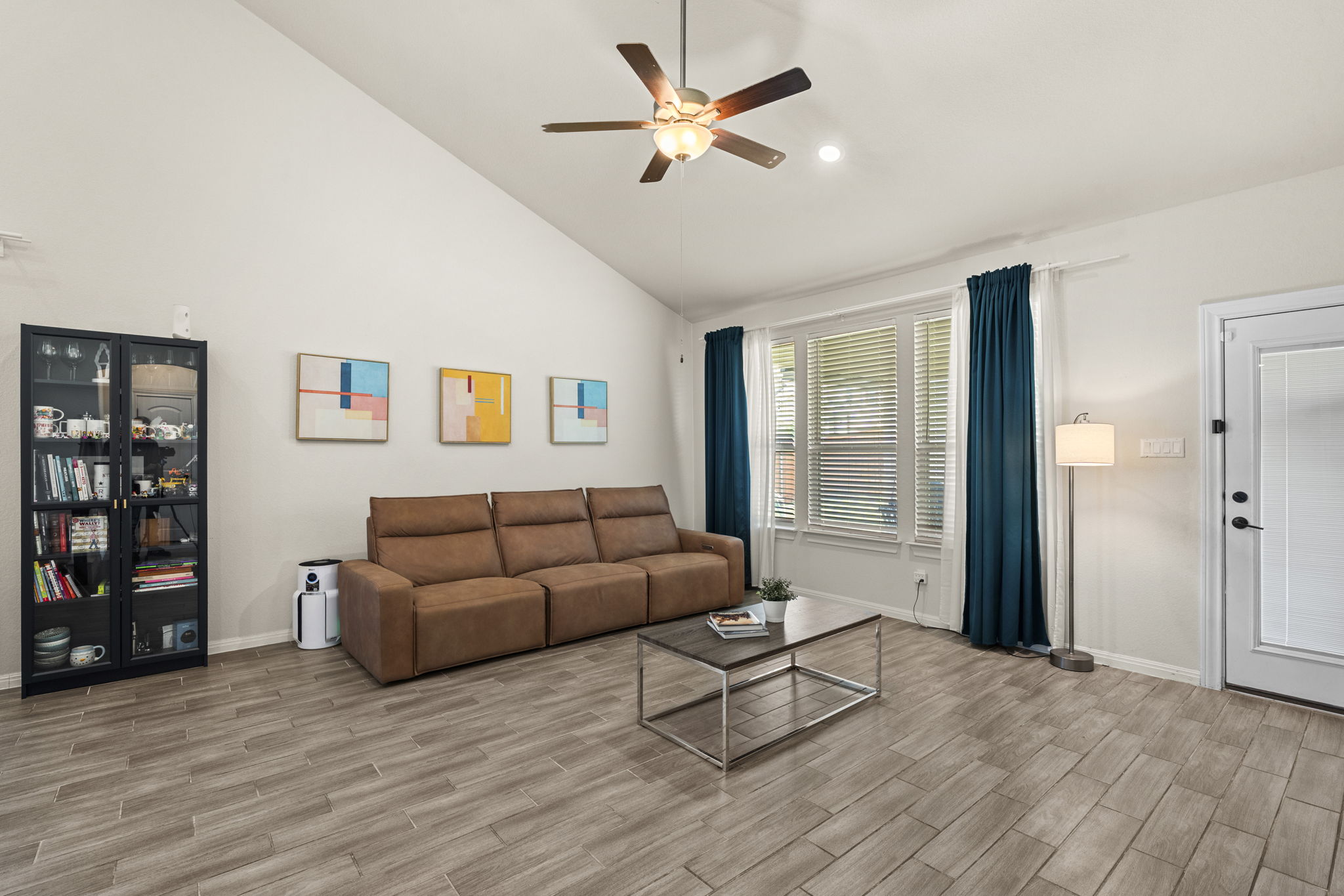 548 Purple Heart Drive Buda, TX 78610 - Photo 17 of 35 Soaring ceilings and elegant tile flooring define this inviting living room, perfect for gatherings.