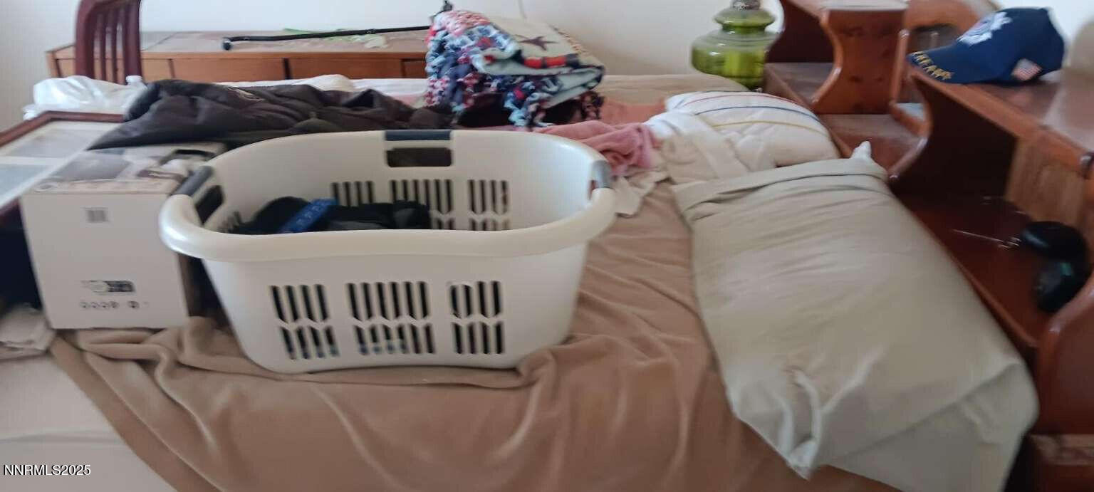 1 Iron Mine Road Crescent Valley, NV 89821 - Photo 23 of 46 a view of a bedroom with a bed and wooden floor