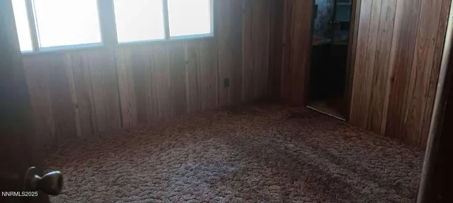 a kitchen with windows and refrigerator
