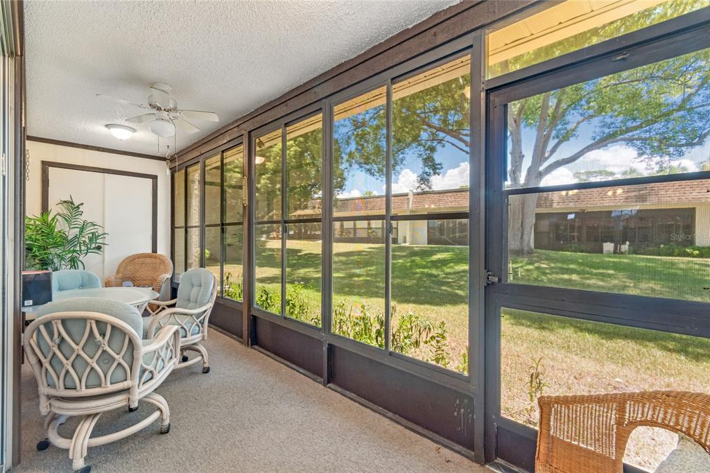 11340 Carriage Hill Drive, Unit 4 Port Richey, FL 34668 - Photo 5 of 36 a view of a dining room with furniture window and outside view