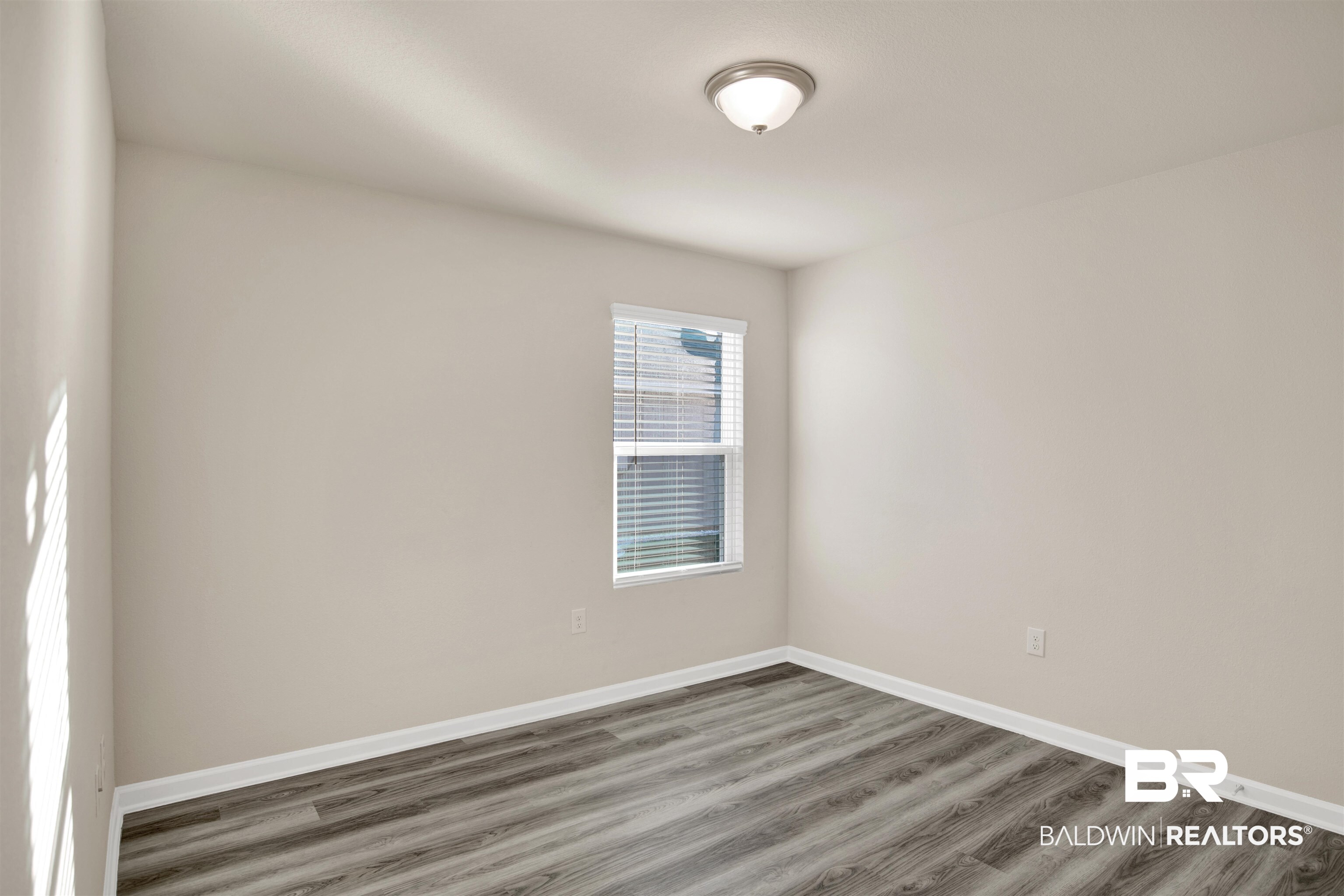 32038 Lyon Road Daphne, AL 36527 - Photo 14 of 30 Unfurnished room featuring baseboards and wood finished floors