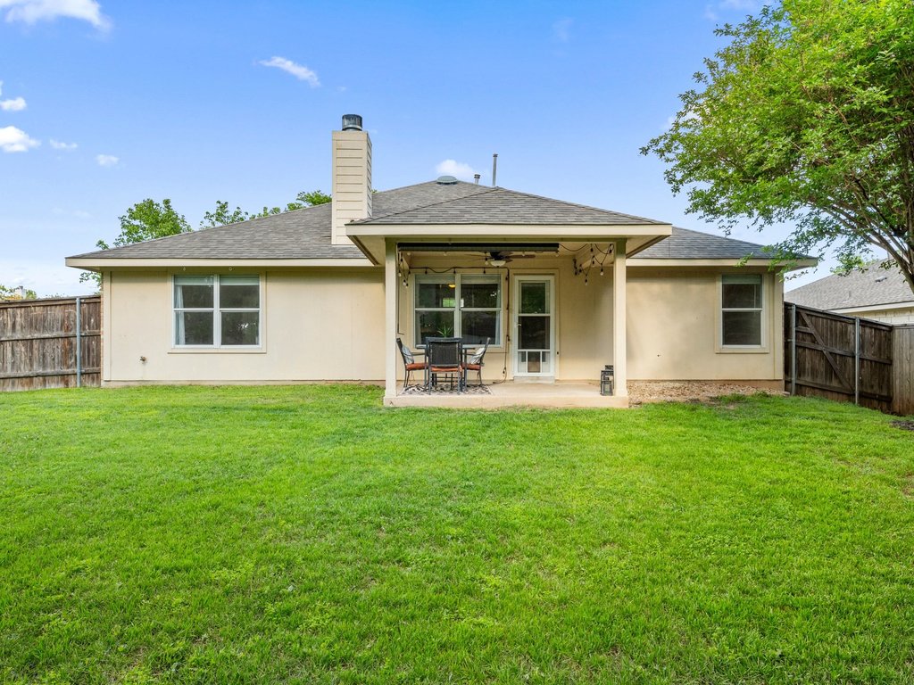 1201 Ridgewood Drive Leander, TX 78641 - Photo 29 of 29 Rear view of house with a shingled roof, a patio area, and stucco siding