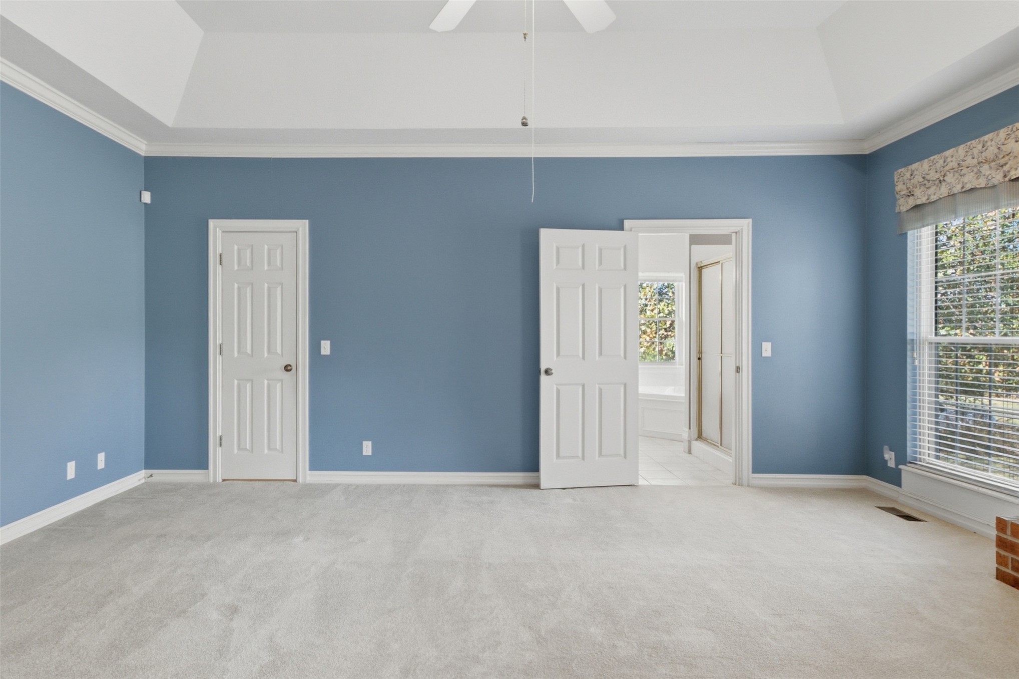 17875 East 589 Road Inola, OK 74036 - Photo 16 of 73 Vaulted ceiling with crown molding, light-colored carpeting, large windows with blinds, and a paneled door