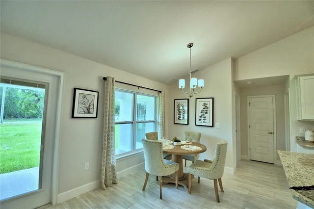 a view of a dining room with furniture and window