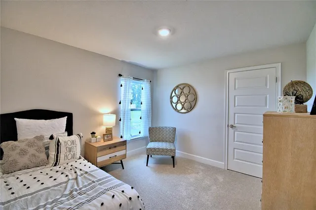 a spacious bedroom with a bed and a couch