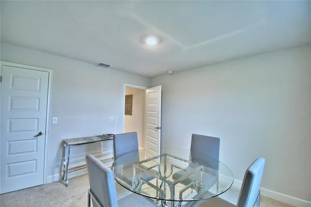 a bedroom with a large bed and a potted plant