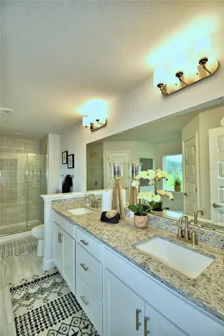 a bathroom with a double vanity sink and a mirror