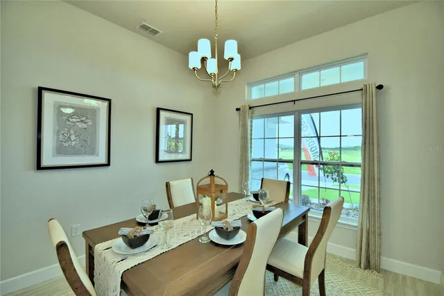 a dining room with furniture and window
