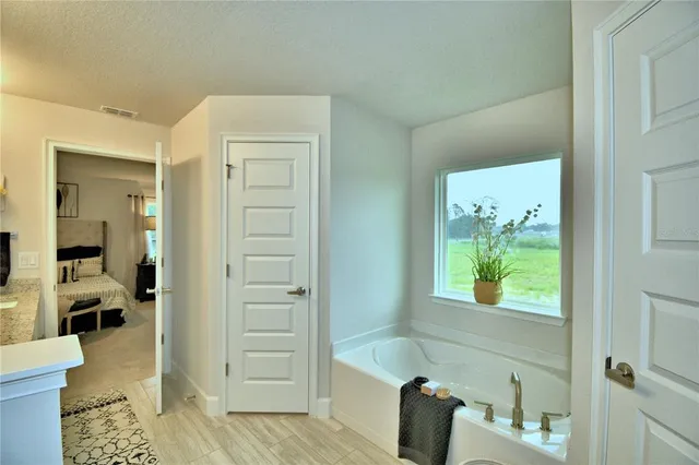 a bathroom with a granite countertop sink a mirror and shower