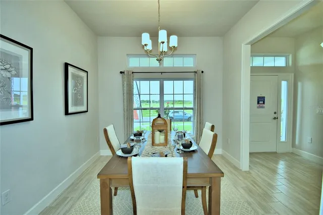 a view of a dining room with furniture window and wooden floor