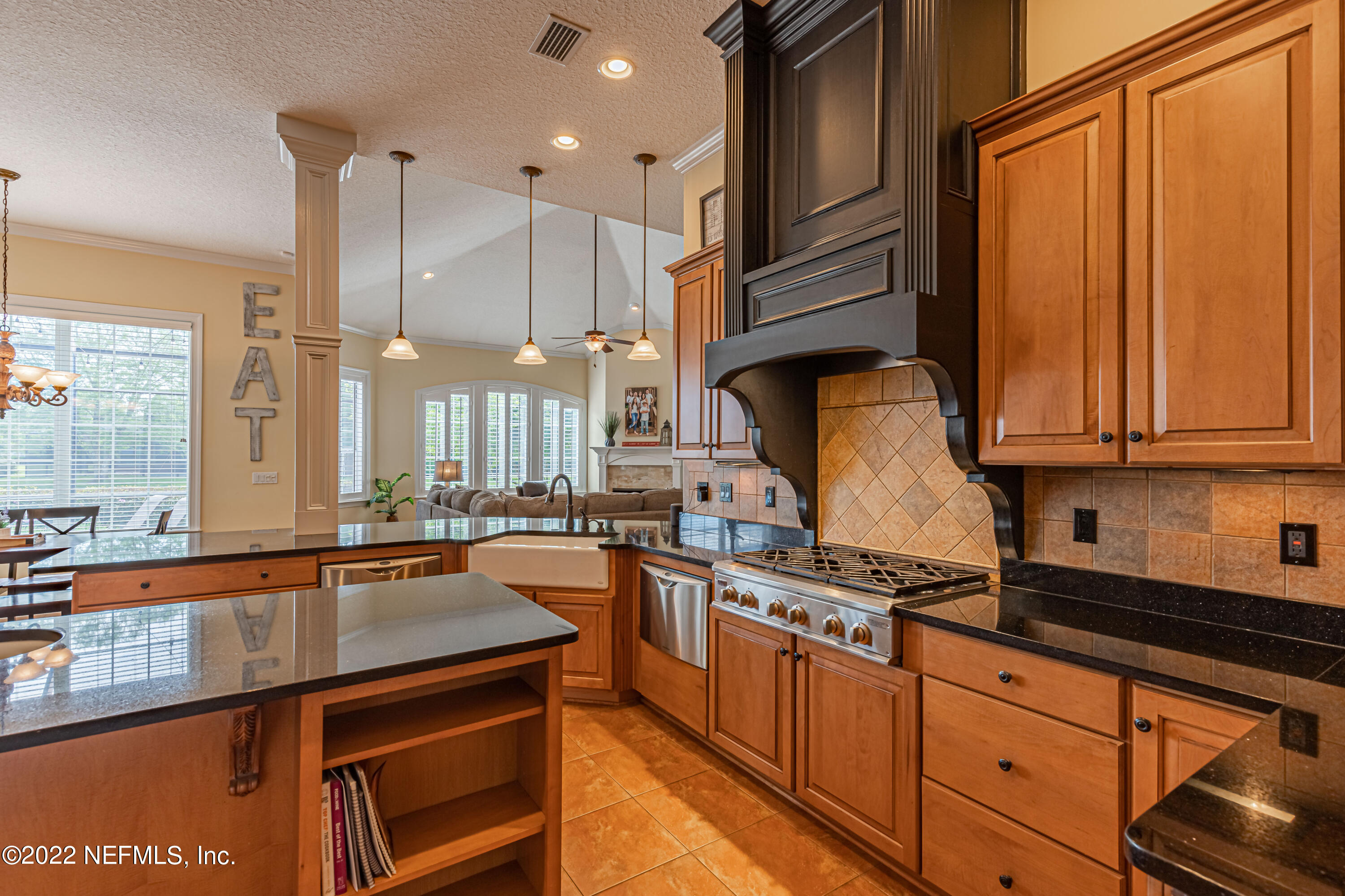 2723 Shade Tree Drive Fleming Island, FL 32003 - Photo 12 of 93 a kitchen with stainless steel appliances granite countertop a sink a stove and a refrigerator