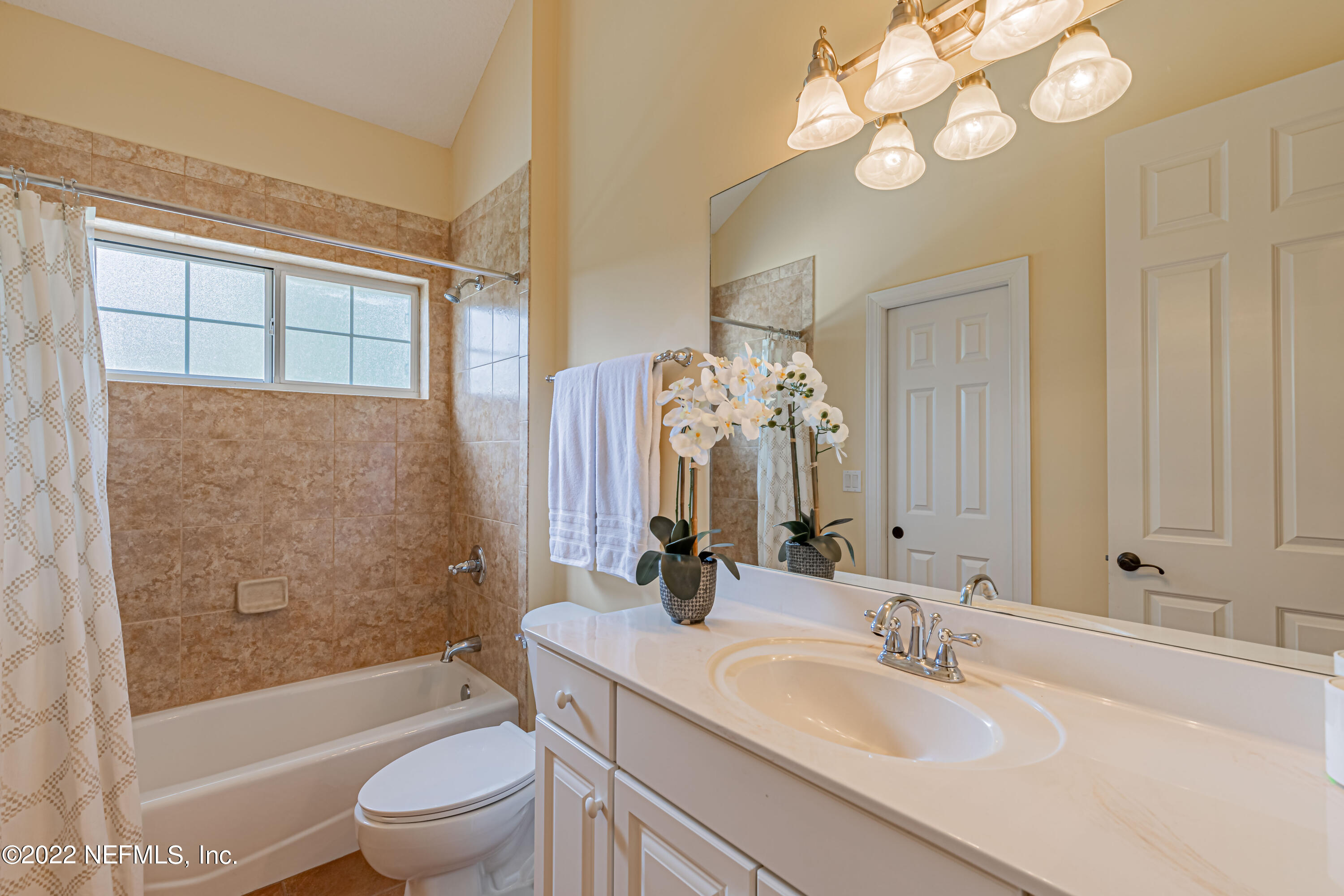 2723 Shade Tree Drive Fleming Island, FL 32003 - Photo 29 of 93 a bathroom with a granite countertop sink a toilet and bathtub
