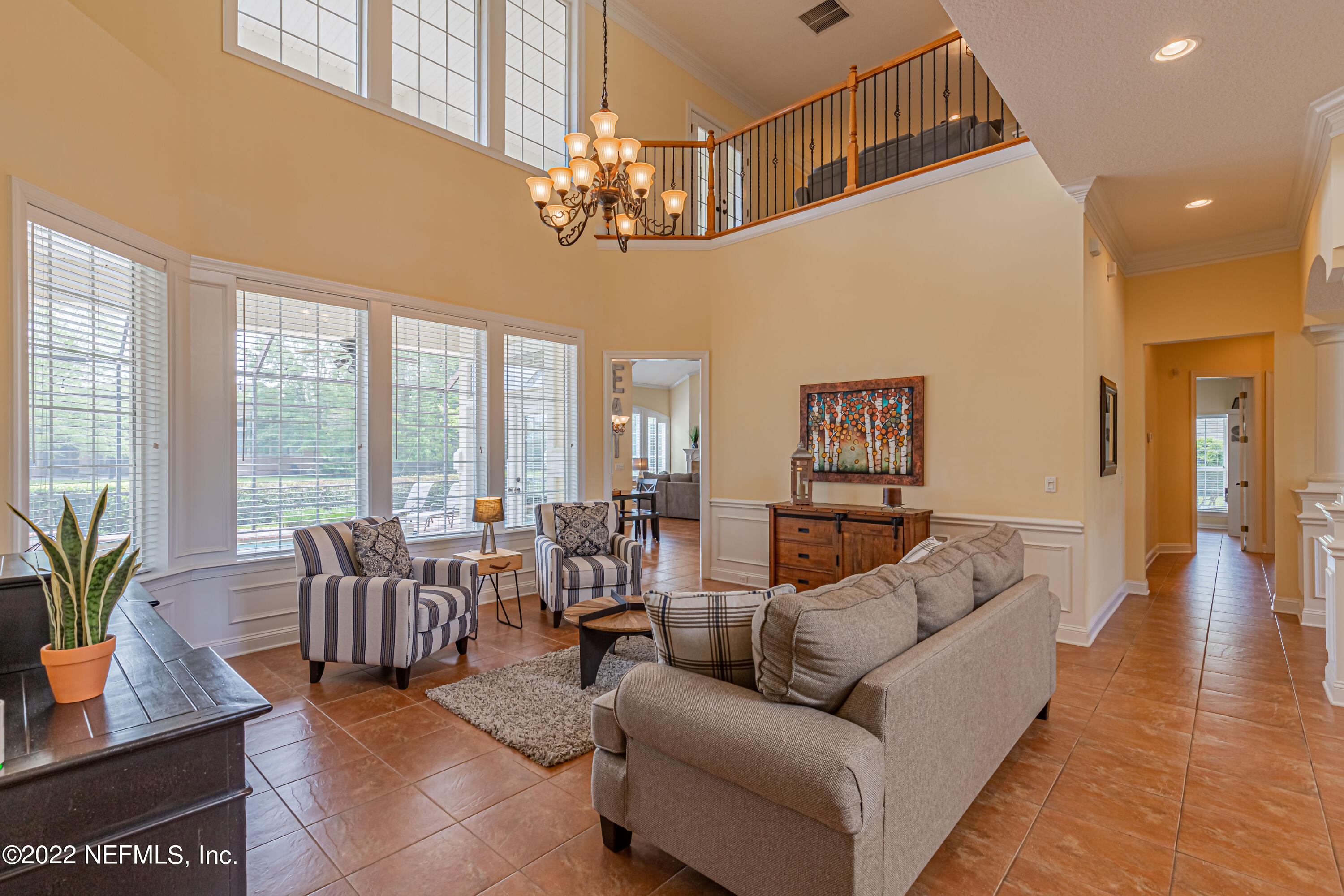 2723 Shade Tree Drive Fleming Island, FL 32003 - Photo 8 of 93 a living room with furniture a chandelier and a dining table