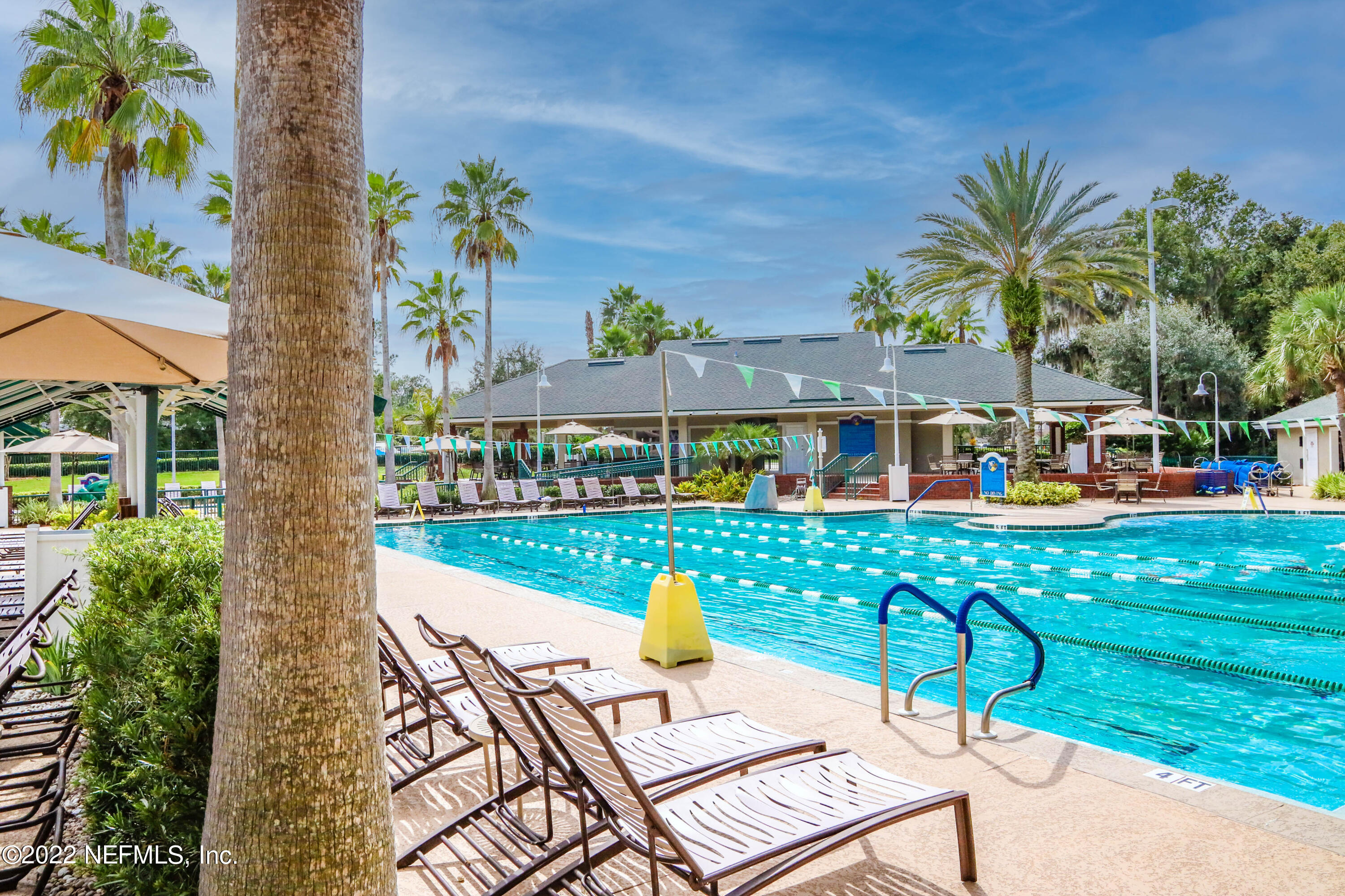 2723 Shade Tree Drive Fleming Island, FL 32003 - Photo 88 of 93 a view of a chairs and table in patio with a lake view