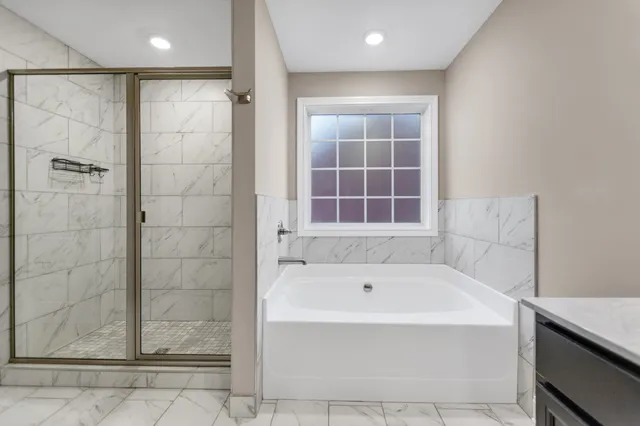 a bathroom with a bathtub and a shower