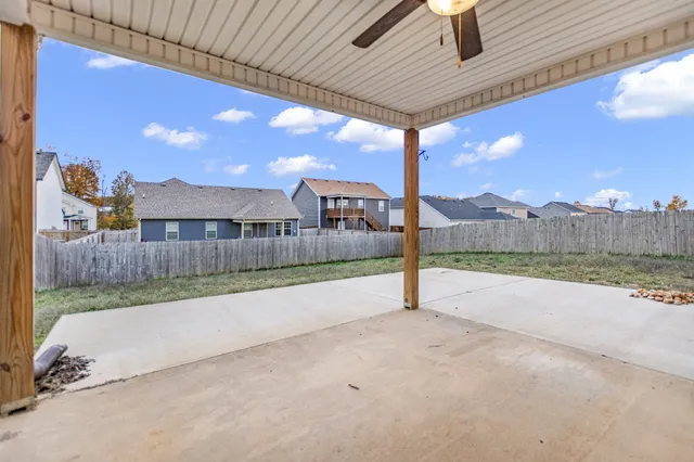 a view of a house with a yard and sitting area