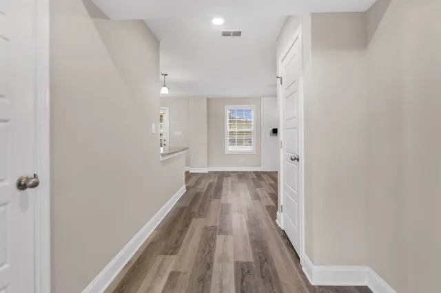 a view of a room with wooden floor and staircase