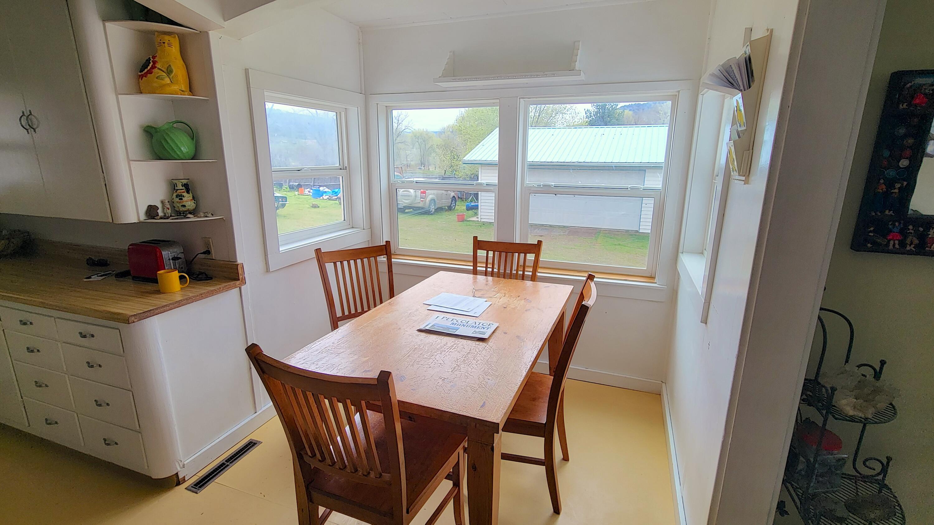 298 Main Street Monument, OR 97864 - Photo 13 of 66 a view of a dining room with furniture and a window