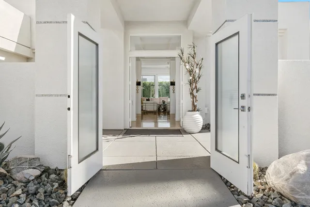 a living room with furniture and a piano