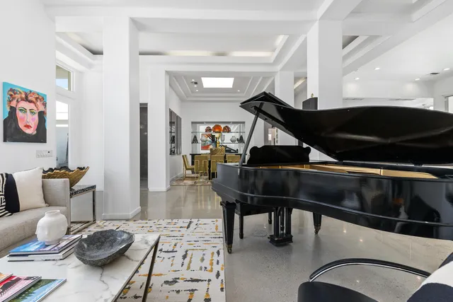 a work room with furniture and a large window