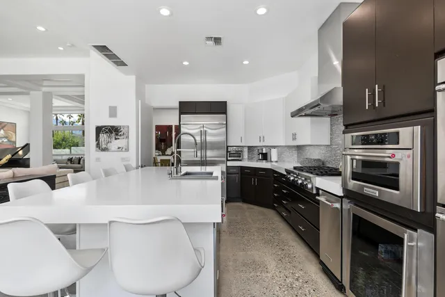 a living room with furniture and a floor to ceiling window