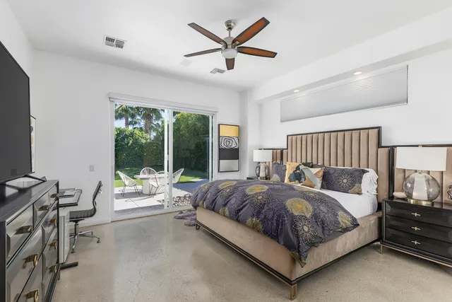 a bedroom with bed and a night stand