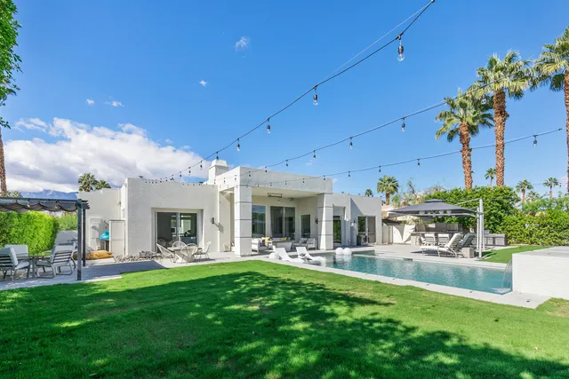 a view of a patio with couches chairs and a fire pit